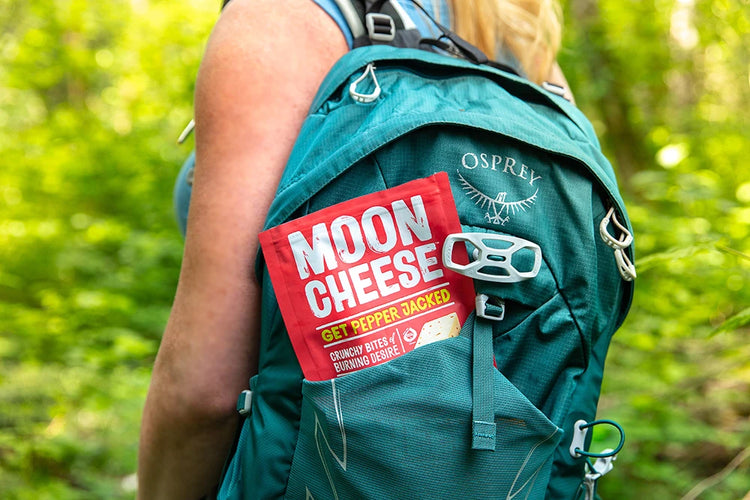 gluten free sugar free keto friendly high protein get pepper jacked moon cheese bag in a green hiker's backpack