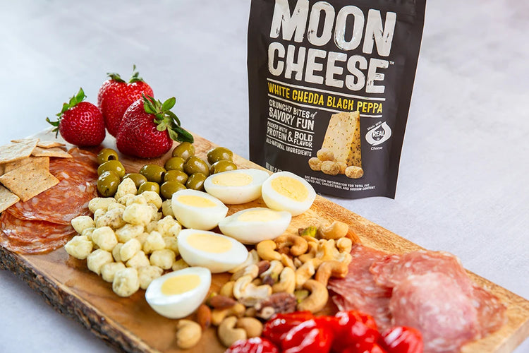 gluten free sugar free keto friendly high protein white chedda black peppa moon cheese with nuts meats and fruit on a grazing board