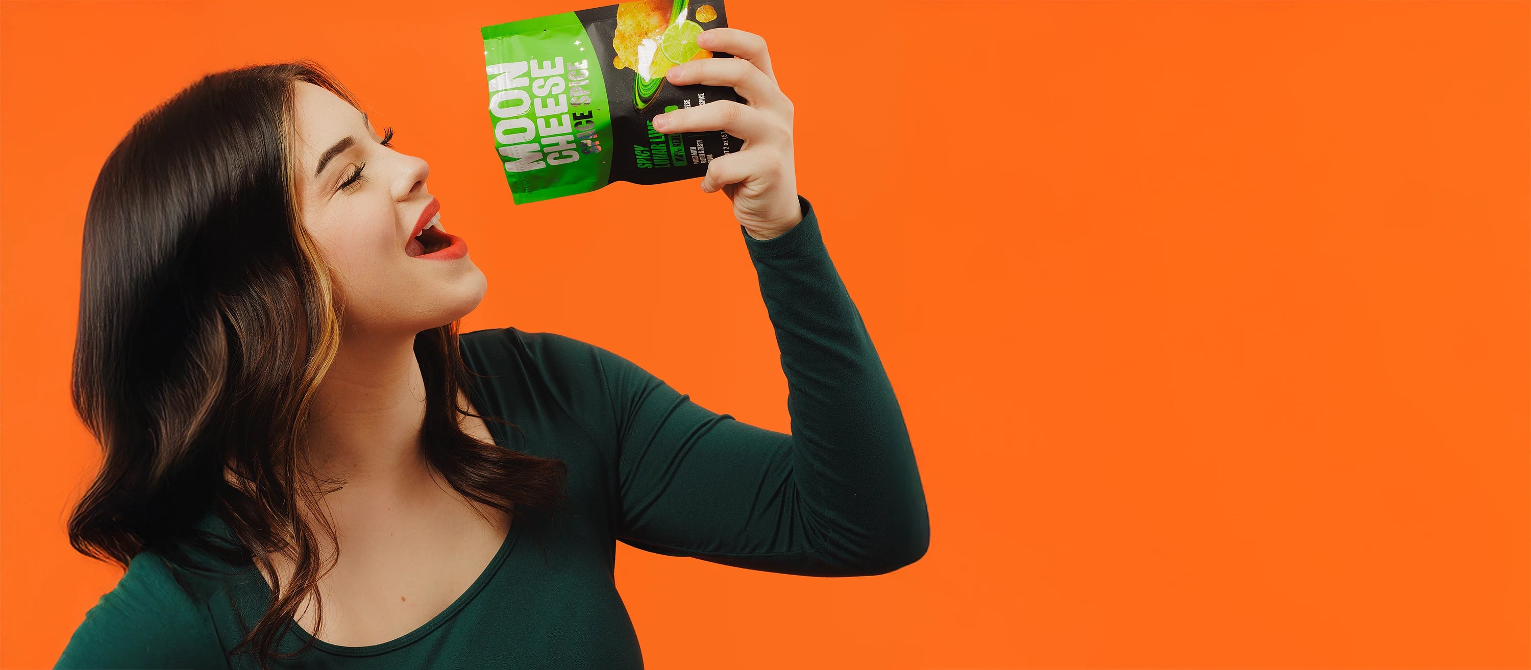 gluten free sugar free keto friendly high protein spicy lunar lime space spice moon cheese being eaten by a young woman